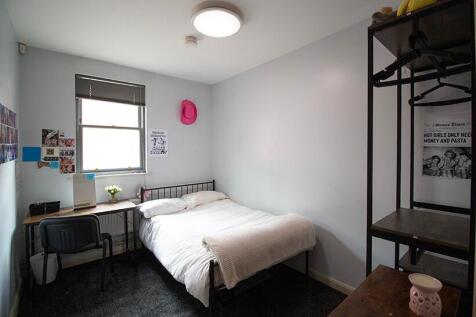 This cozy double bedroom features a comfortable...