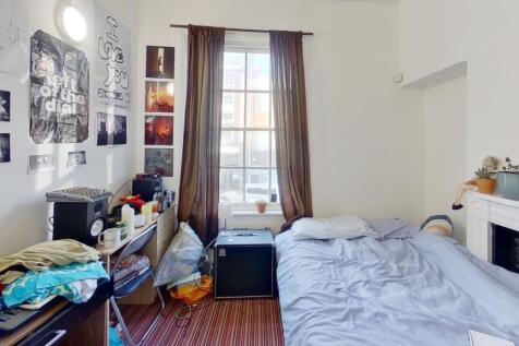 A bright and inviting master bedroom featuring ...