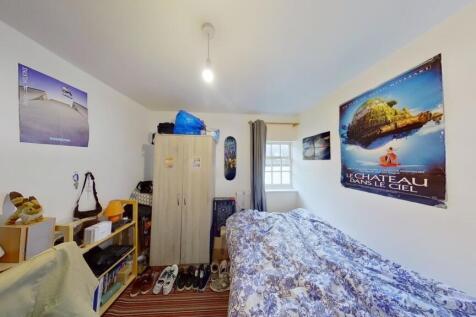 A bright and tidy student toilet with clean whi...