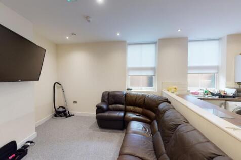 A cozy living room featuring a large brown leat...