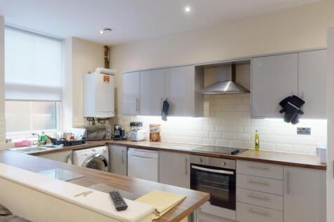 Bright and modern kitchen featuring sleek cabin...