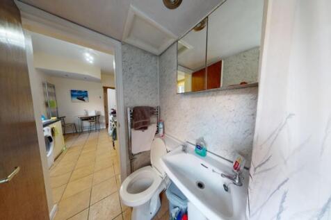 A neat bathroom featuring a white sink with mir...