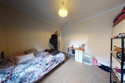 Cozy single bedroom featuring a comfortable bed...