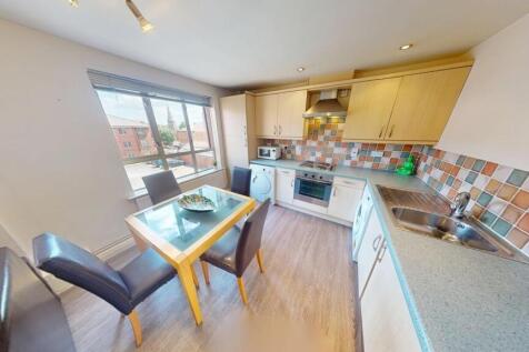 Bright and modern kitchen featuring tiled backs...