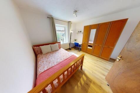 Bright and inviting master bedroom with a comfo...