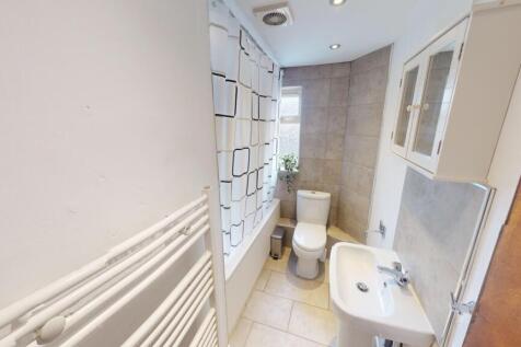 A clean and functional bathroom featuring a whi...