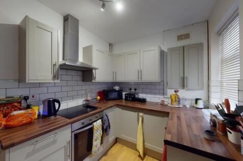 Bright and modern kitchen featuring wooden coun...