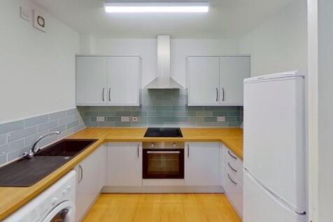 Bright and modern kitchen featuring clean woode...