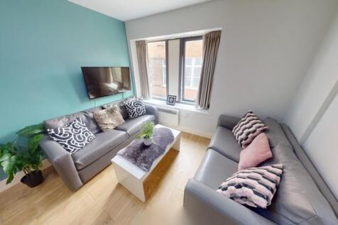 Bright and cozy living room featuring two comfo...