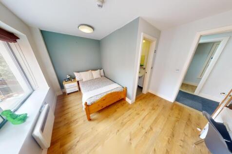 Bright and cozy single bedroom featuring a larg...