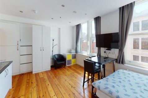 Bright and spacious bedroom featuring a comfort...