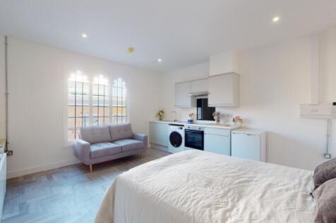 A spacious and modern kitchenette with ample na...
