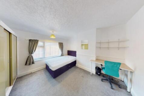 Bright and spacious double bedroom featuring a ...