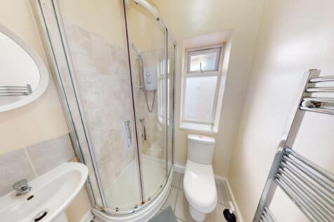 A modern bathroom featuring a sleek shower unit...