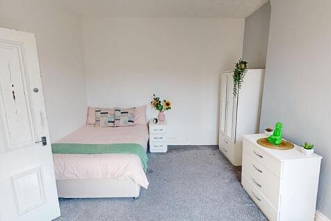 A bright and inviting double bedroom with moder...