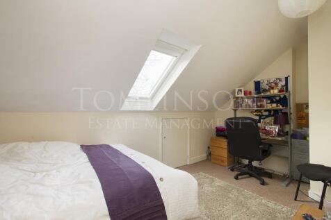 A cozy and well-kept master bedroom featuring a...