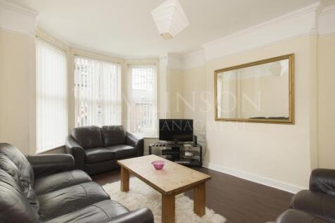 A bright and inviting living room featuring com...