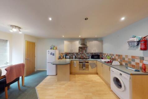A spacious and tidy kitchen with modern applian...
