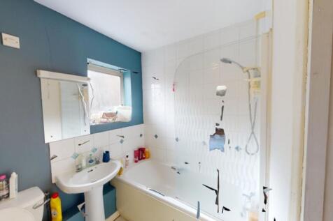 A well-maintained bathroom featuring a bath and...