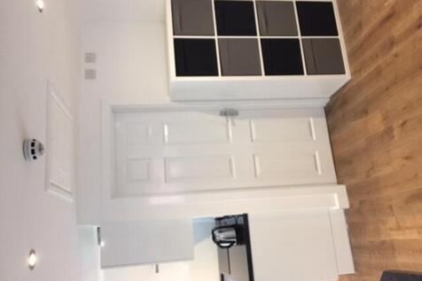 A bright and clean kitchenette with modern cabi...