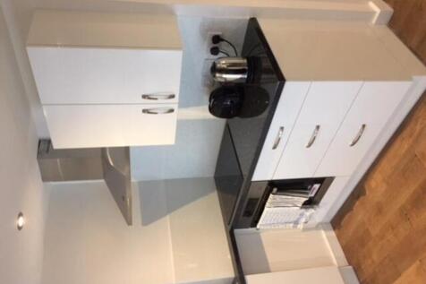 A modern and tidy kitchenette featuring stylish...