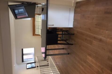 A bright and modern kitchenette with ample spac...