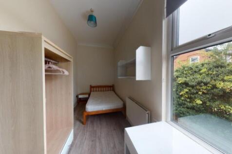 Bright and tidy single bedroom featuring a cozy...