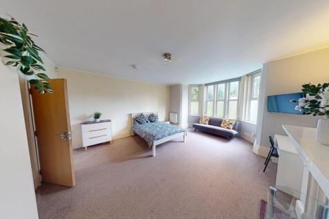 A spacious and inviting master bedroom featurin...