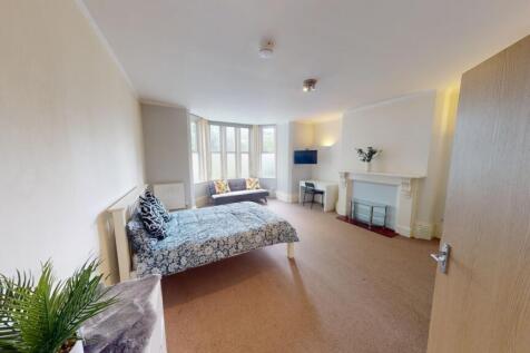 Bright and spacious master bedroom featuring a ...
