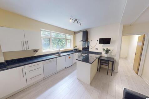 Bright and modern kitchen featuring ample count...