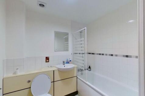 Bright and clean bathroom featuring a combined ...