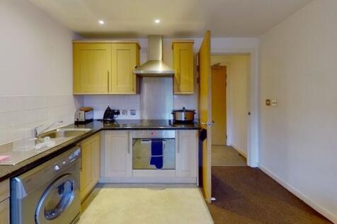 Bright and tidy kitchen featuring modern applia...