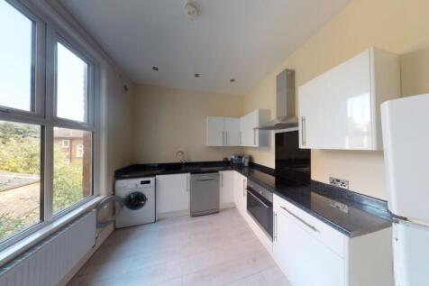 Bright and modern kitchen featuring ample natur...