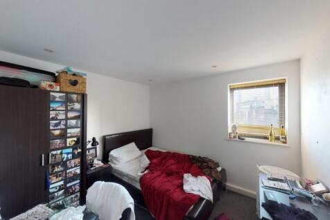 Cozy single bedroom featuring a comfortable bed...