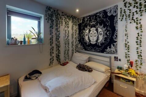 A cozy, well-decorated double bedroom featuring...