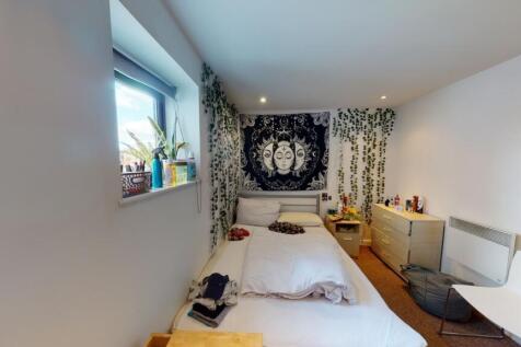A cozy and modern double bedroom featuring a co...