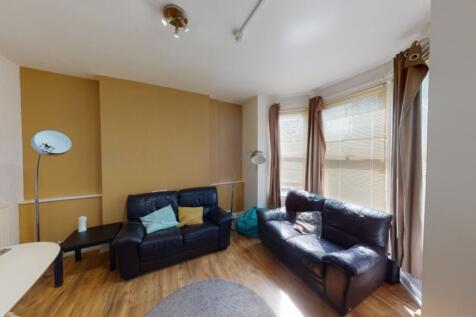 A spacious and inviting modern living room, per...