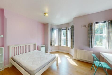 A bright and spacious double bedroom with large...