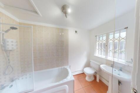 A spacious and bright large bathroom featuring ...