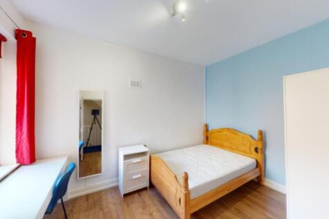 A bright and inviting double bedroom featuring ...