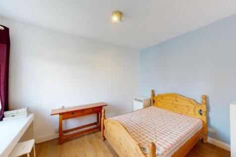 A bright and inviting double bedroom featuring ...