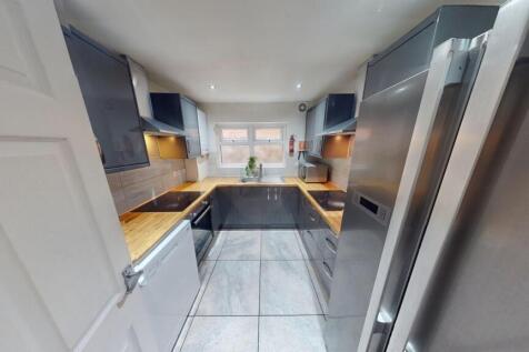 A modern kitchen featuring sleek cabinetry, bui...
