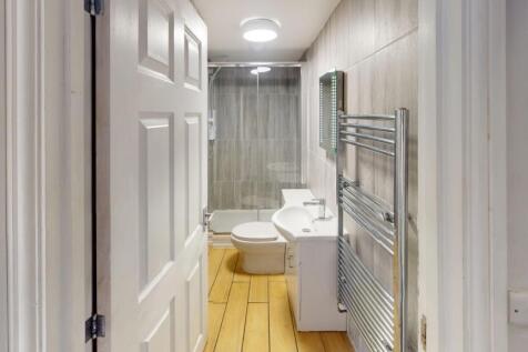 A modern and well-maintained bathroom suite fea...