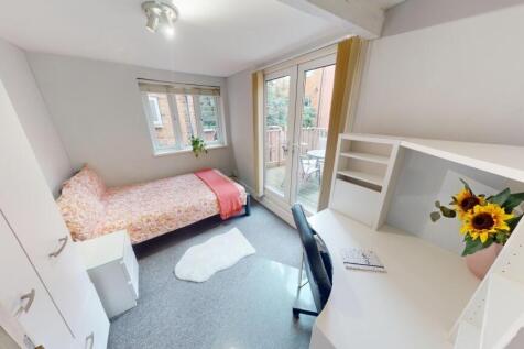 A bright and cozy single bedroom featuring a co...