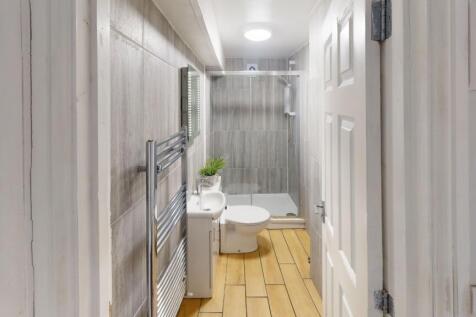 A modern bathroom featuring a white toilet and ...