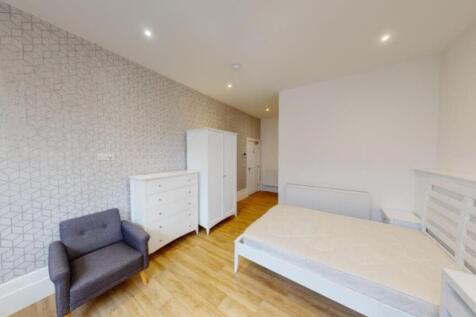 A spacious and bright double bedroom featuring ...