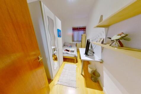 Bright and tidy single toilet room featuring cl...