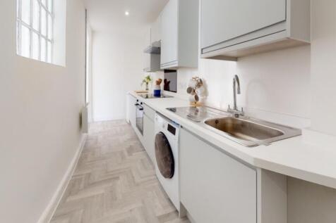 A modern and spacious kitchenette featuring amp...