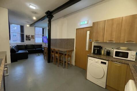 A spacious communal lounge area featuring a wel...