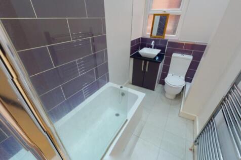 A modern bathroom featuring a bath and shower, ...